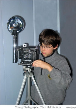 Young Photographer with Old Camera Tools web